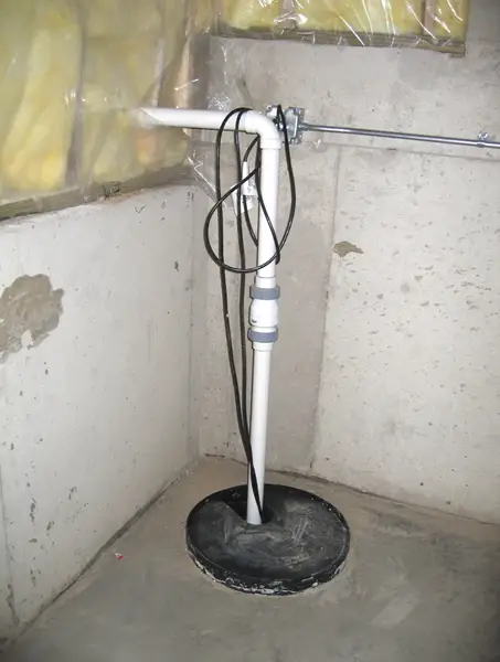 A typical sump pump basement installation in a poured concrete basement. Image credit DOE